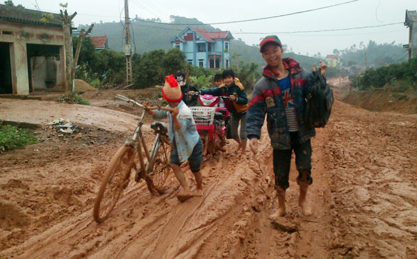 Đẹp lắm nụ cười em thơ trên con đường đầy bùn đất