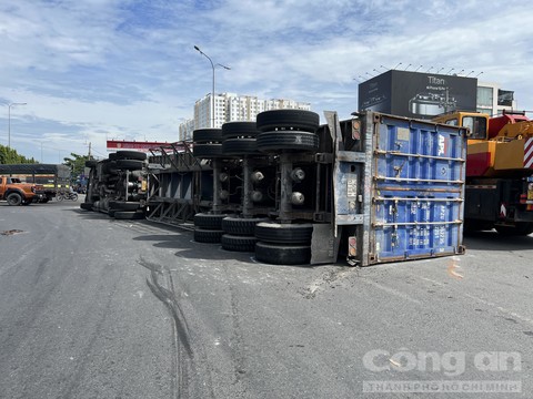 container nga nhao xuong duong xe co chon chan giua trua nang 1 container nga nhao xuong duong xe co chon chan giua trua nang 1