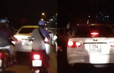 Chạy xe trên cầu Long Biên, lái xe ô tô bị cô gái chửi, quay clip