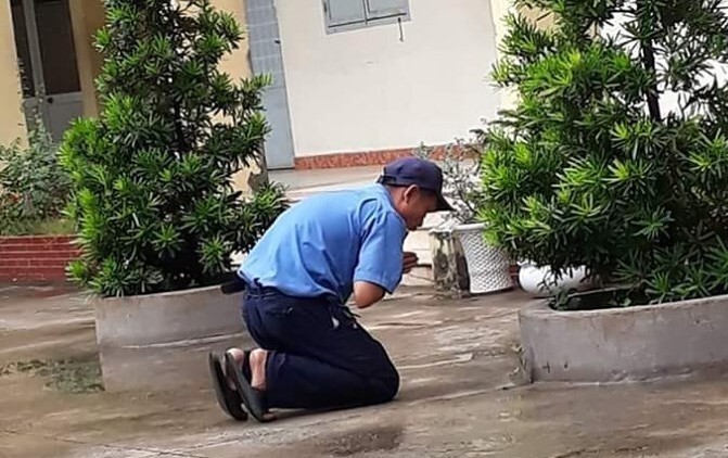 Hình ảnh bác bảo vệ quỳ một góc sân trường cầu cho học sinh đỗ tốt nghiệp 100% gây bão mạng xã hội