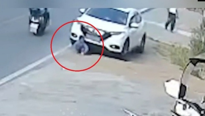 Clip: Lạnh người trước cảnh bé trai ngồi chơi trước ô tô bị đâm ngã, cuốn vào gầm