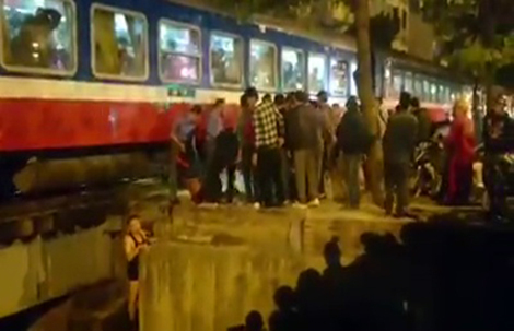 Ngồi gần đường ray, một phụ nữ bị tàu hỏa hất văng xuống sông Lừ