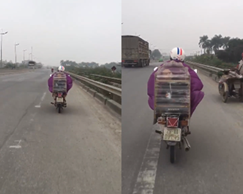 Xôn xao clip trời giá rét mẹ đi xe máy, chở con trai trong lồng chim 