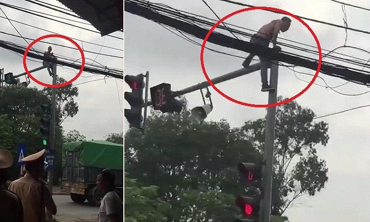 Video: Bị CSGT giữ xe, nam thanh niên trèo lên cột đèn giao thông ăn vạ