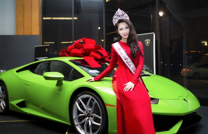 Hoa hậu Jennifer Chung diện áo dài đỏ tạo dáng bên xế hộp