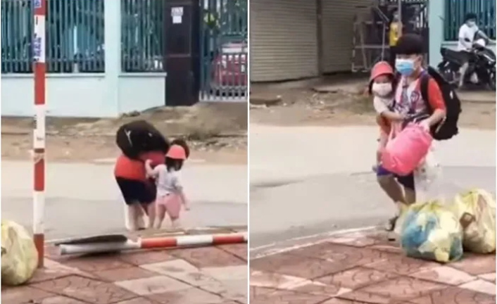 Cha mẹ F0 đều đã đi cách ly, bé trai tất bật xách túi đồ, một bên