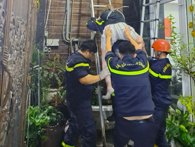 Cảnh sát dùng thang tiếp cận, đưa nạn nhân xuống mặt đất an toàn. Ảnh: Dân trí