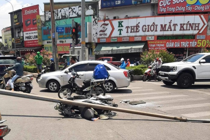 Cột đèn chiếu sáng đè lên chiếc xe máy của cô gái. Ảnh: VietNamNet
