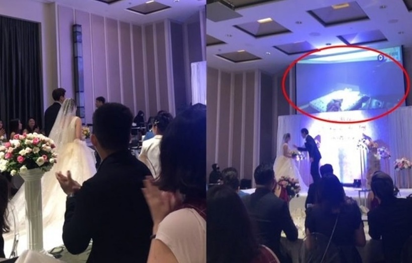 Màn hình lớn của hôn trường chiếu đoạn clip cảnh nóng ân ái của cô dâu và một người đàn ông lạ.Ảnh: Asia1.