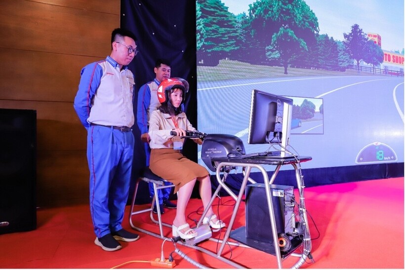 Giáo viên trải nghiệm các tình huống mô phỏng trên máy tập lái xe cùng hướng dẫn viên của Honda Việt Nam (Ảnh: HVN).