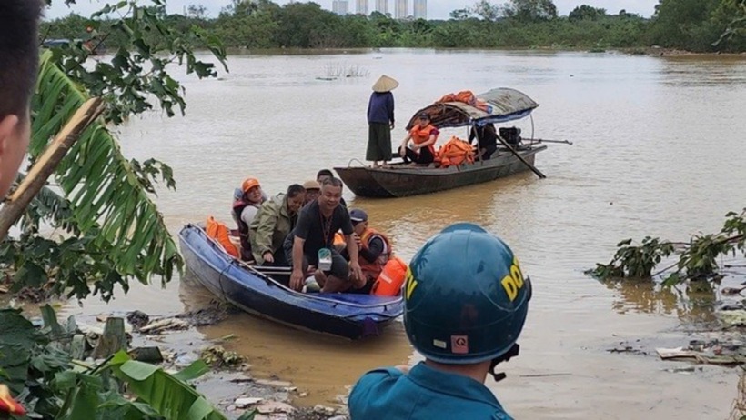 Người dân dùng thuyền để chuyển đồ đạc ra khỏi vùng ngập lũ. Ảnh: Sức khoẻ & Đời sống