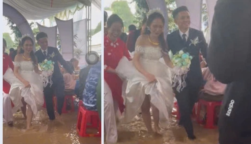 Cô dâu chú rể tươi rói trong ngày vui dù đám cưới ngập trong biển nước. Ảnh: Tiền Phong
