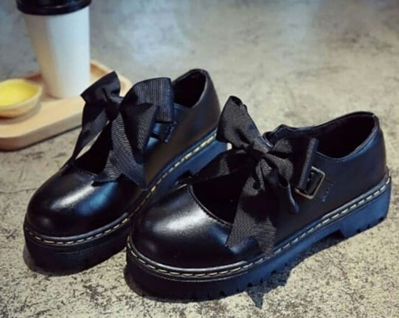Giày búp bê đen gắn nơ to, rườm rà dễ khiến tổng thể trang phục trông sến sẩm. Ảnh minh họa
