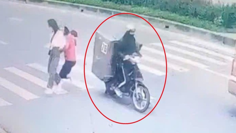 Hình ảnh xe máy có thùng sắt chở thịt heo gây tai nạn đã rời khỏi hiện trường. (Ảnh cắt từ clip)