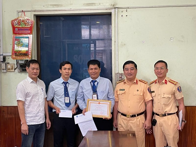 Lãnh đạo Phòng CSGT Công an tỉnh Bình Định trao tặng giấy khen của Giám đốc Công an tỉnh cho ông Nguyễn Đức Lợi. Ảnh: Công an nhân dân
