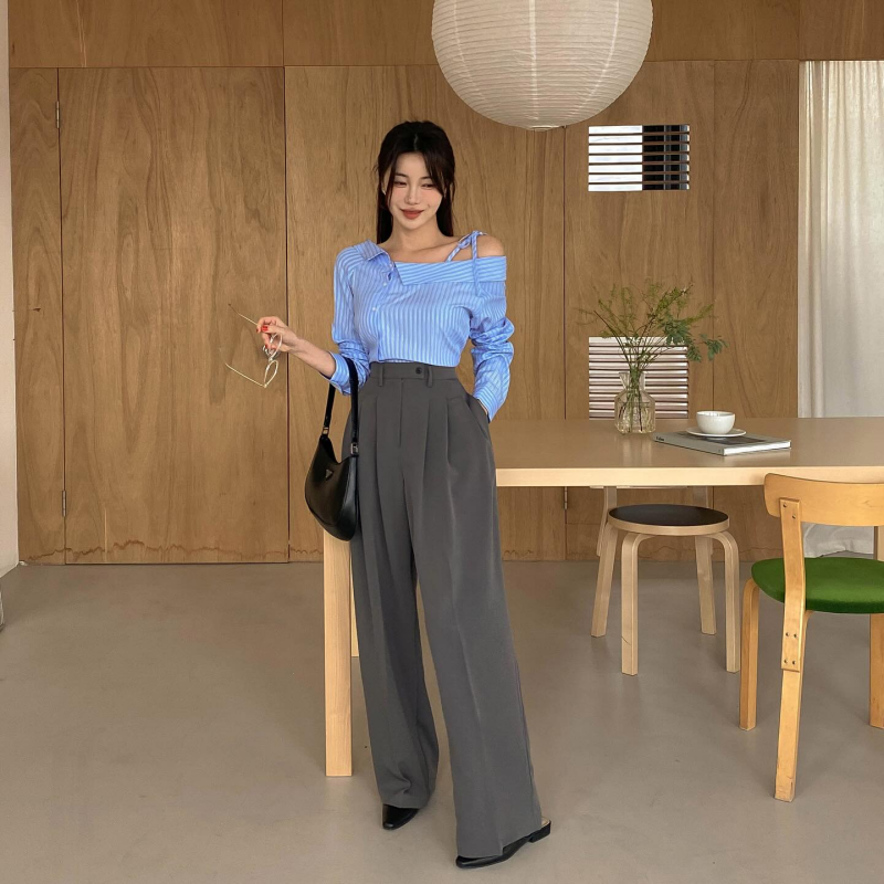 Áo kẻ sọc tạo điểm nhấn bắt mắt cho outfit mix quần âu xám đóng vai trò cân bằng tổng thể trang phục. Túi xách và giày mule tông màu đen đều là những lựa chọn phù hợp với bộ đồ.