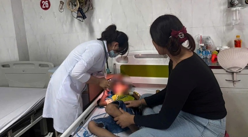 Bác sĩ kiểm tra sức khỏe cho bé trai. Ảnh: PLO