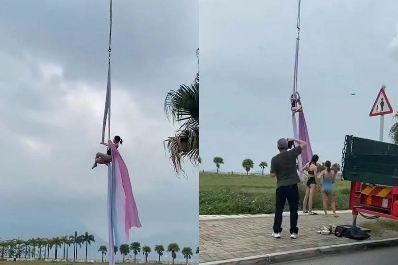 Một người phụ nữ mặc trang phục bó sát đang treo lơ lửng giữa không trung ở độ cao khoảng 5 mét bằng dây đai yoga. Ảnh: HK01.