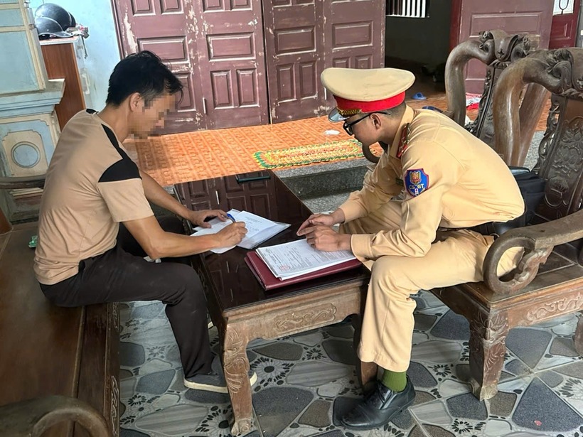 Tài xế H làm việc với lực lượng CSGT sau khi húc gãy gác chắn đường sắt. (Ảnh: Báo Xây dựng)