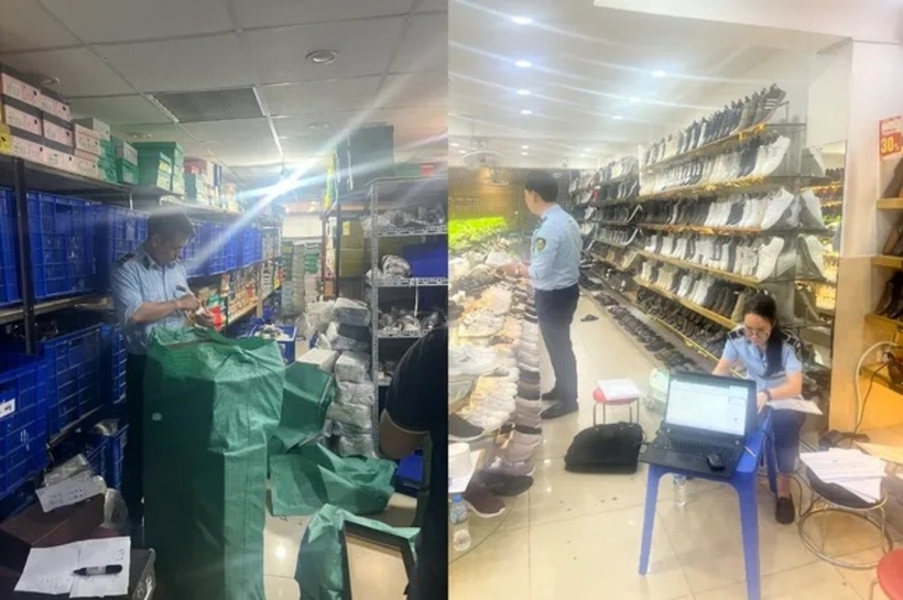 Lực lượng chức năng kiểm tra cơ sở kinh doanh giầy dép ở Cầu Giấy (Hà Nội). Ảnh: Tiền Phong