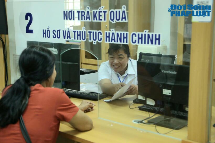Cán bộ UBND Phường Đông Ngạc hướng dẫn người dân làm các thủ tục hành chính.