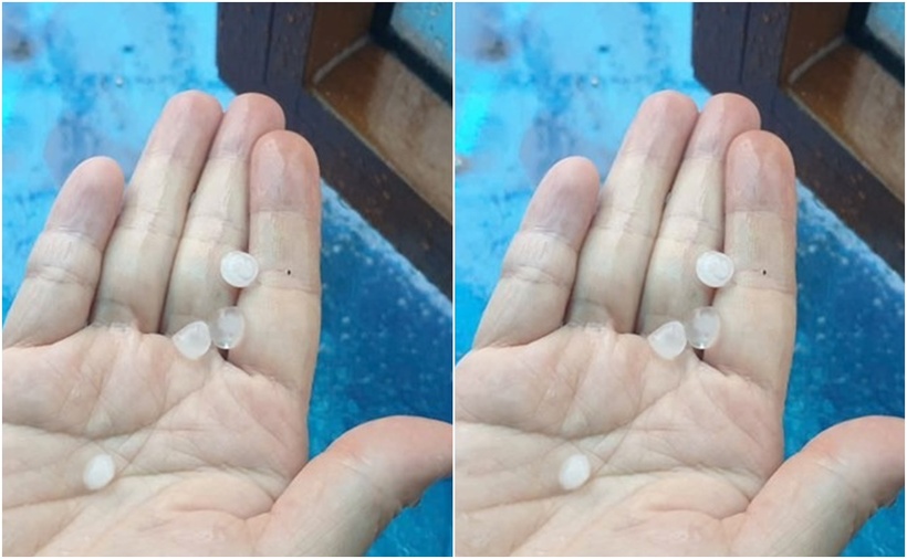 Người dân đưa tay qua cửa sổ hứng được mưa đá. (Ảnh: Lao động)