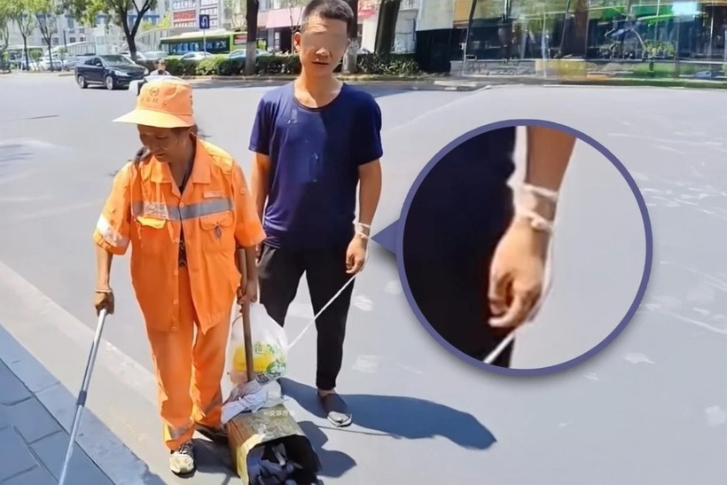 Người mẹ dẫn theo con trai thiểu năng đi làm việc cùng. Ảnh: Baidu