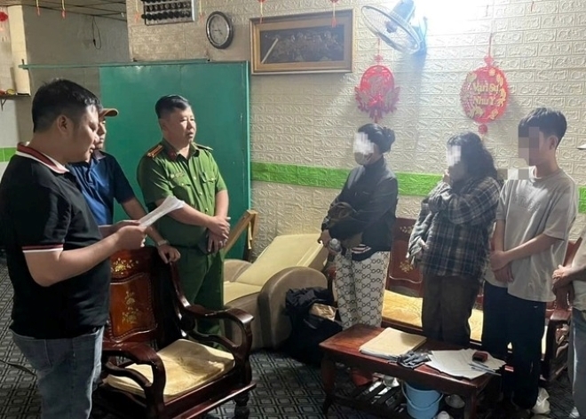 Công an làm việc với những người tham gia hoạt động mua bán dâm tại cơ sở massage D.K. Ảnh: Báo Thanh niên