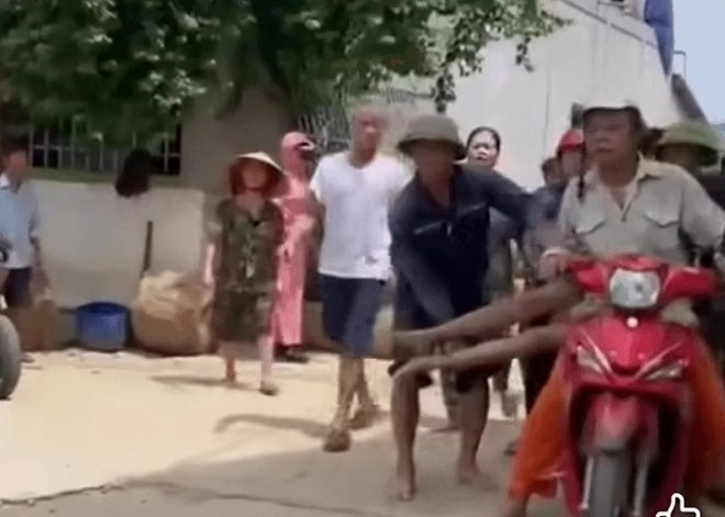 Sau khi bị ong đốt, anh N. được người dân đưa từ bờ sông về nhà bằng xe máy để đưa đi cấp cứu. Ảnh: Lao động