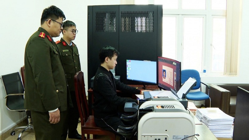 Đối tượng Phạm Duy Phú (áo đen) cầm đầu đường dây sản xuất, mua bán giấy tờ giả. Ảnh: CAND