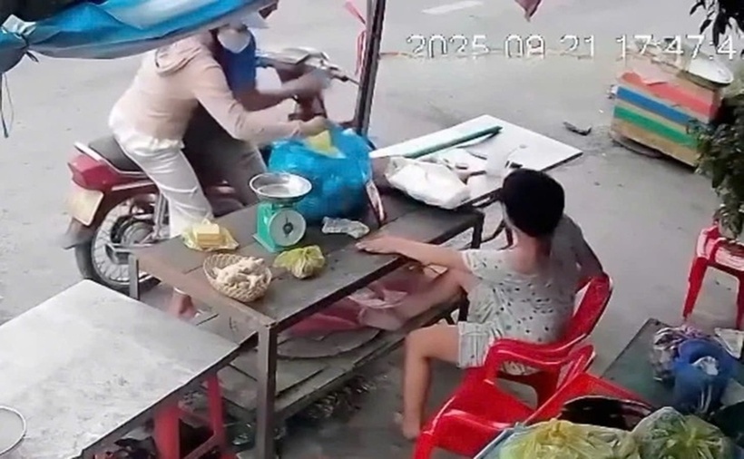 Hình ảnh đôi nam nữ cướp giật điện thoại của người khuyết tật bán hàng bên đường. (Ảnh: Tuổi trẻ)