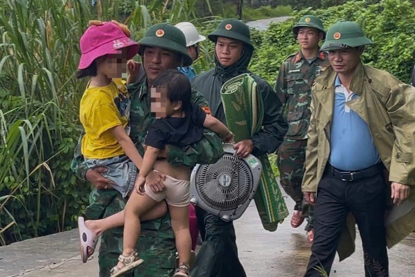 Lực lượng chức năng đưa trẻ nhỏ vào hầm trú bão. (Ảnh: Dân trí)