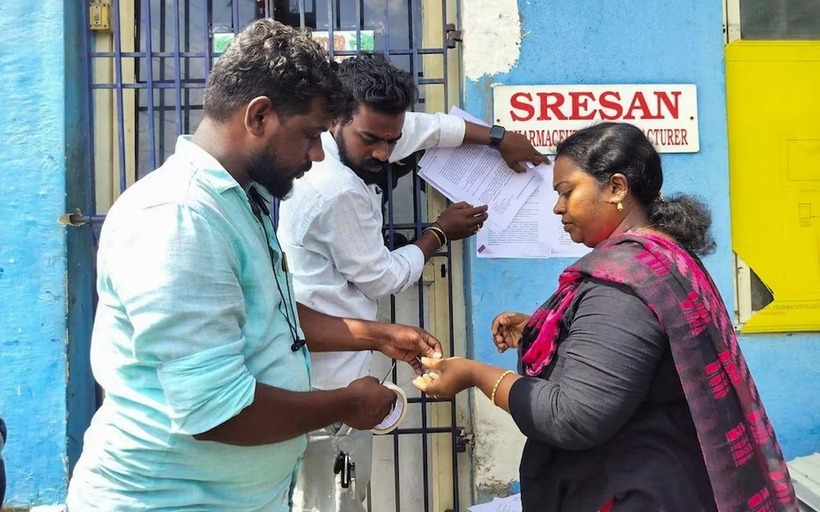 Một viên chức y tế tiểu bang dán thông báo bên ngoài nhà máy dược phẩm Sresan, nơi có siro ho Coldrif có liên quan đến cái chết của nhiều trẻ em ở Madhya Pradesh, tại Chennai, Ấn Độ. Ảnh: Getty