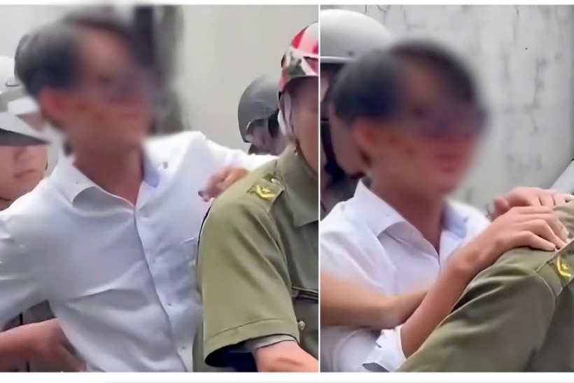 Nam thanh niên mặc áo trắng bị lực lượng an ninh cơ sở đưa đi. Ảnh: Báo Tiền phong.