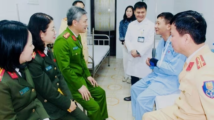Lãnh đạo Công an tỉnh Thanh Hóa thăm hỏi Đại úy Đỗ Quốc Dũng. (Ảnh: CACC/VietNamNet).
