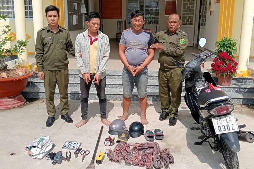Lợi (áo khoác) và Giống bị công an bắt giữ vì cắt trộm dây điện ở Tây Ninh. Ảnh: Dân trí