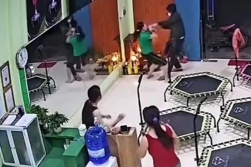 Người đàn ông bịt mặt xông vào khống chế một phụ nữ. Ảnh: PLO