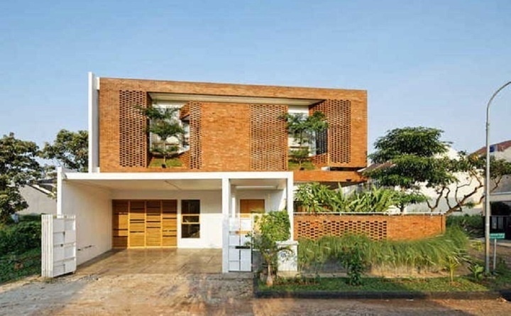 Mẫu nhà gạch không tô được thiết kế hiện đại, thoáng mát, gần gũi với thiên nhiên. Ảnh: Vinavic