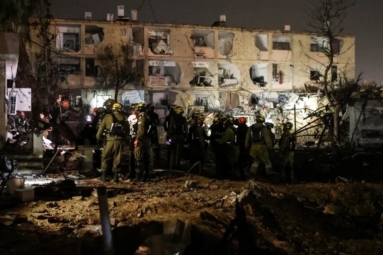 Các lực lượng ứng cứu khẩn cấp tại hiện trường vụ tấn công bằng tên lửa đạn đạo của Iran ở thành phố Arad, miền Nam Israel tối 21/3/2026. Ảnh: TTXVN phát