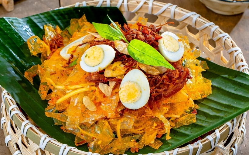 Bánh tráng trộn Sài Gòn với đầy đủ topping như xoài xanh, trứng cút, khô bò, đậu phộng và nước sốt đậm đà hấp dẫn.