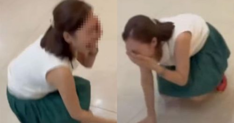 Người phụ nữ ngồi sụp xuống, la hét, kêu mình bị đánh khi tranh cãi với tài xế. (Ảnh cắt từ clip)