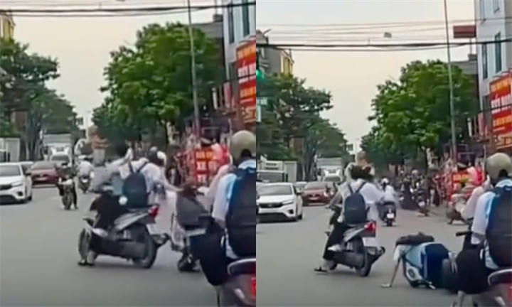 Nữ sinh bị bạn giật tóc, kéo ngã ra đường. Ảnh: Dân trí