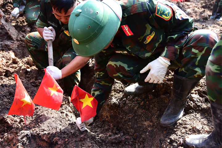 Máy cuốc hỗ trợ đào, xử lý đất tại khu vực tìm kiếm trong Công viên Lê Thị Riêng.