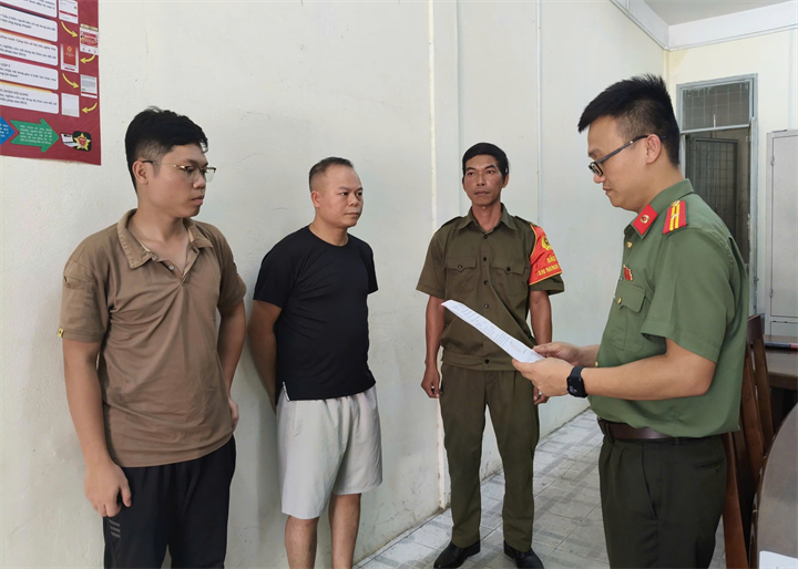 Cơ quan An ninh điều tra Công an TP Đà Nẵng tống đạt các quyết định đối với Chu Đức Anh (áo đen) và Nguyễn Trung Hiếu (ngoài cùng bên trái).